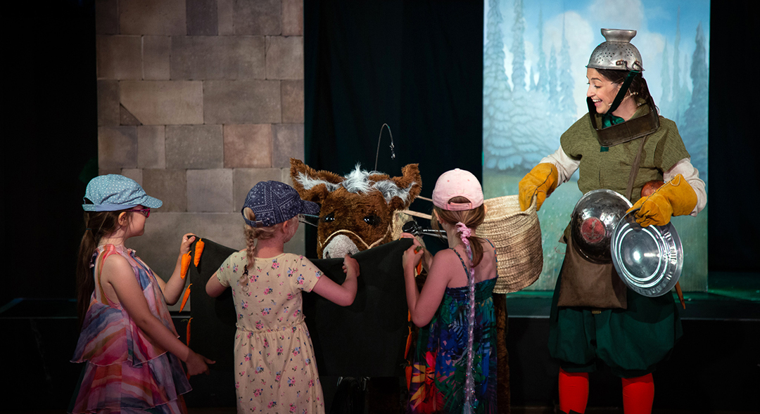 Natasha performing on stage with a few children volunteers in Will Tell. Photo Roarke Pierce